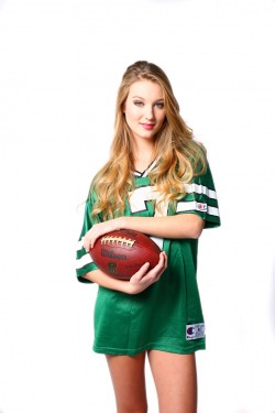 Blonde woman in football jersey in boudoir photography