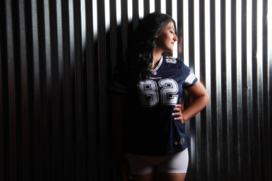 Glamour Shots Woman poses for boudoir photography in football jersey